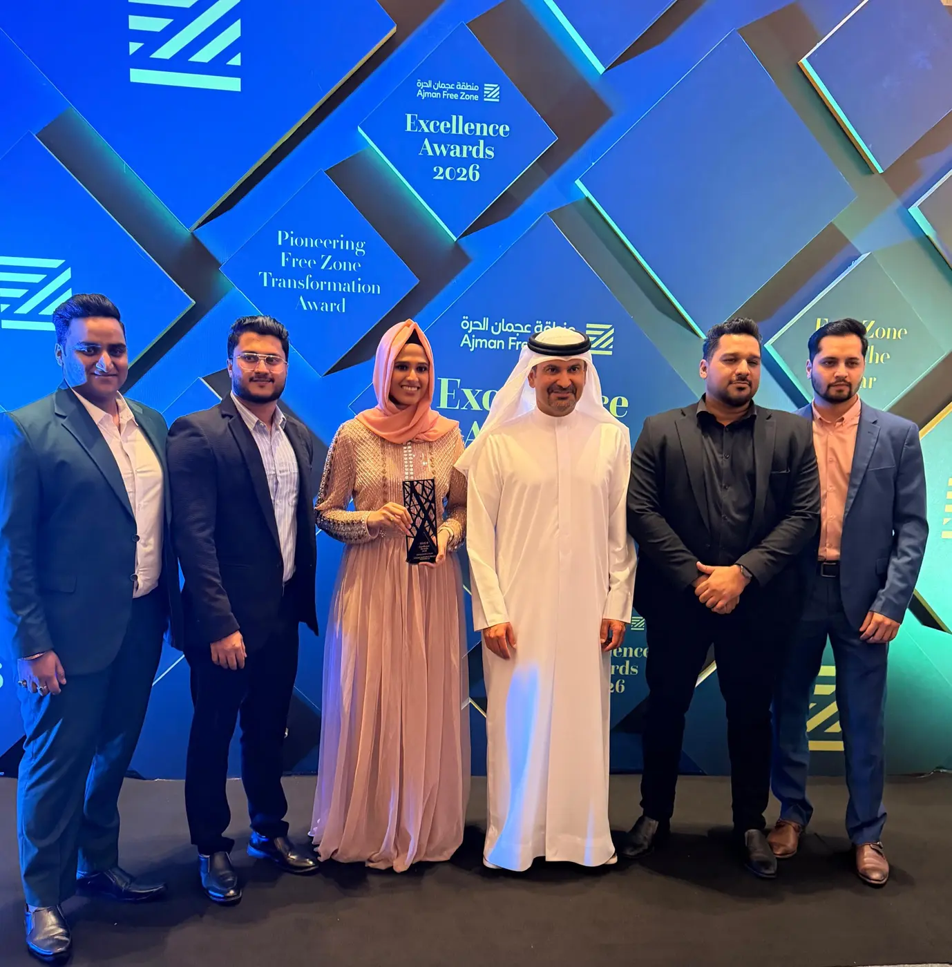 Kinzaad team receiving recognition at the Ajman Free Zone Excellence Awards 2026